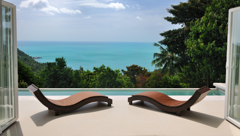 Brown chaise lounges at private pool villa