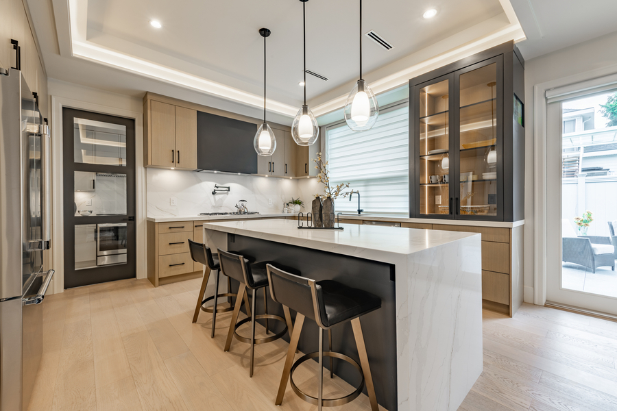 Kitchen interior with bar stools white countertops wooden cabinets